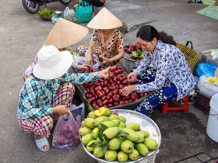 five destinations cheap budget travel vietnam ho chi minh city ladies market apples
