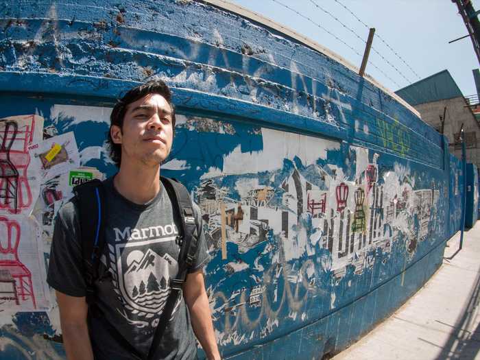 Posing in front of art walls.