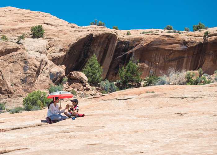 A mother and child taking a break on the trail.