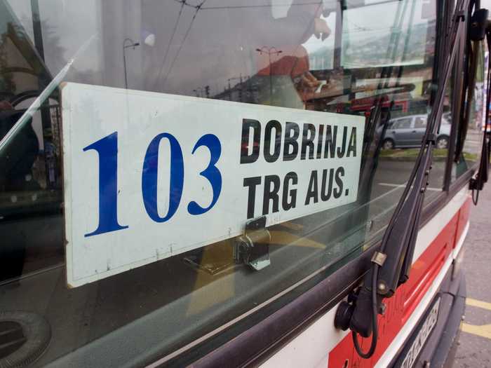 The bus number is in the front window of the bus.