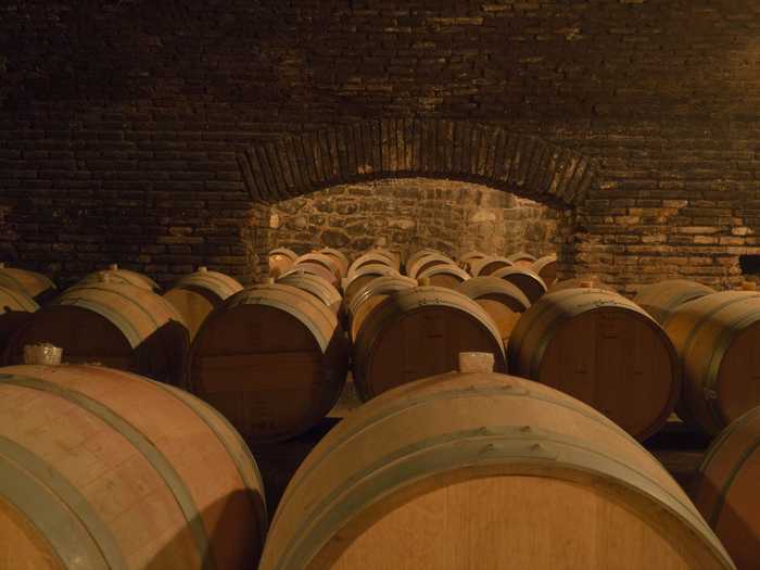 Barrels of aging wine locked in their cellars