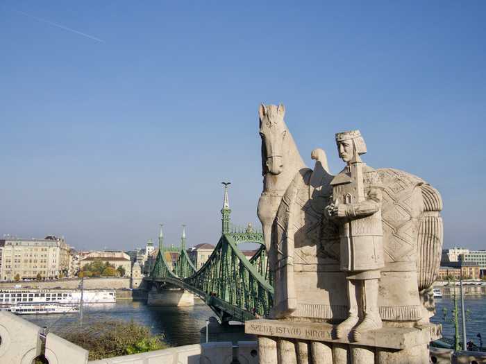 Bridge and statue views mark the bottom of the hill